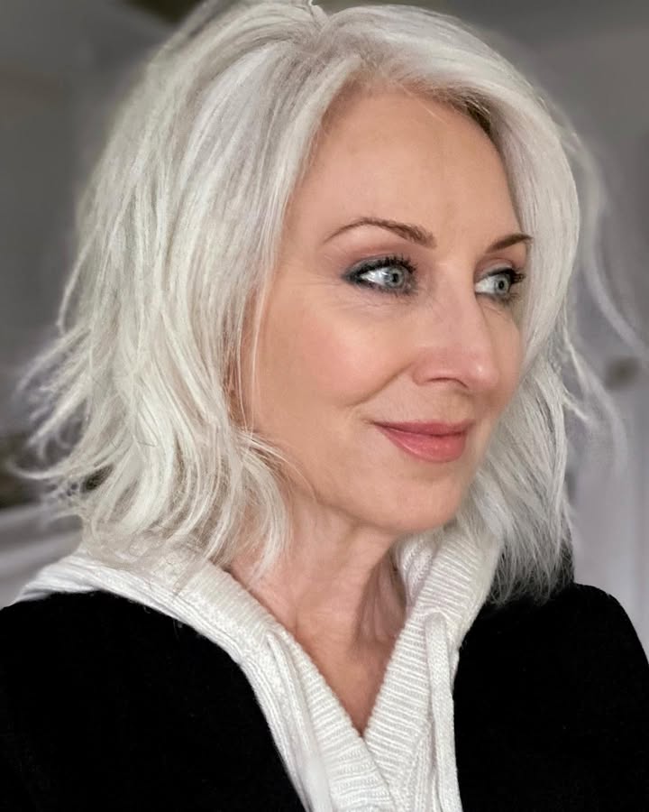 Shoulder length silver hair with soft layers and natural movement.