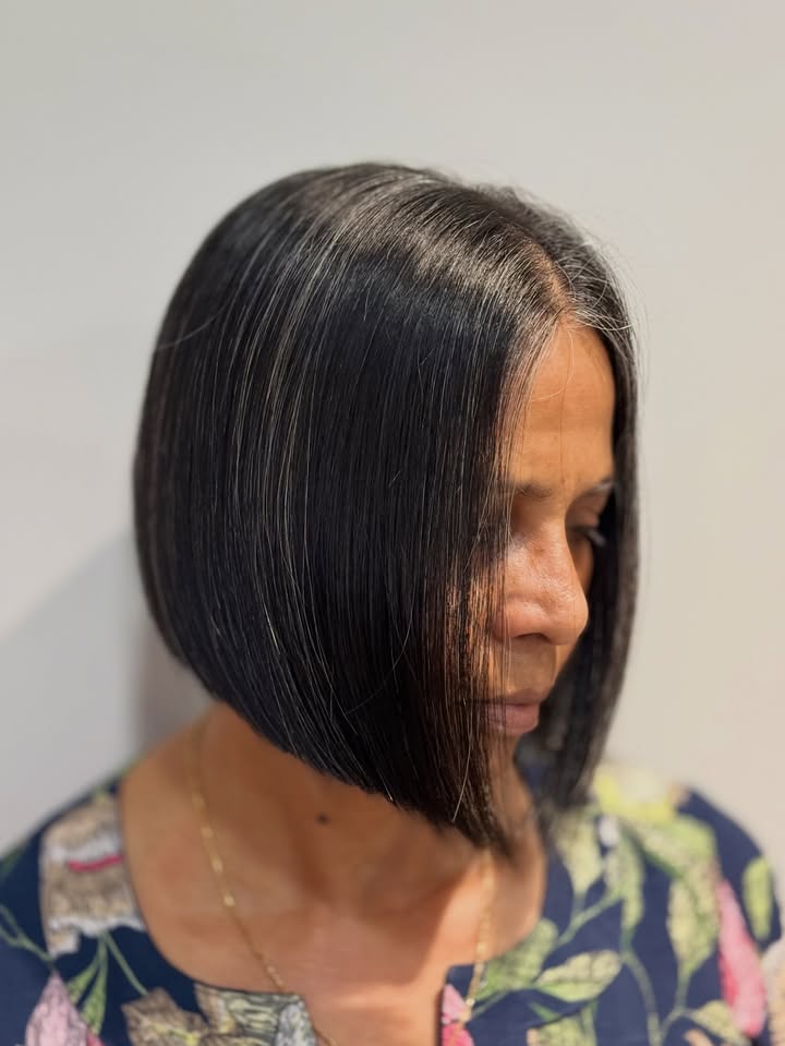Chin length sleek blunt bob with straight dark hair and a smooth finish.
