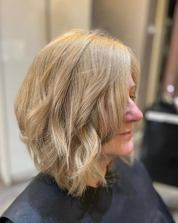 Chin length wavy blonde bob with soft layers and natural movement.
