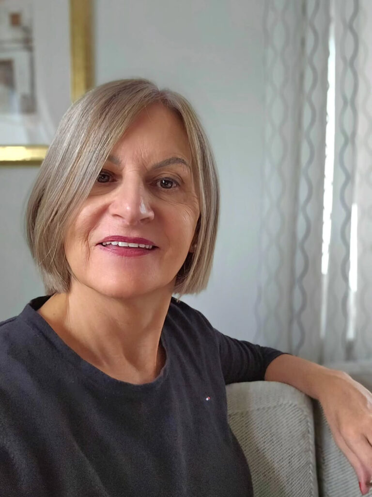 A woman with a sleek ash-blonde angled bob styled with a deep side part.