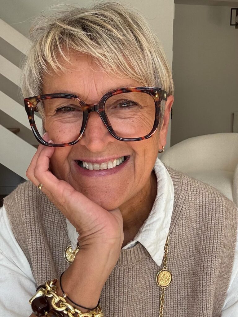 Short blonde pixie haircut with soft textured layers and light volume.