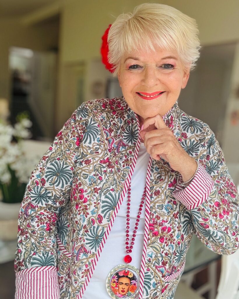 Short blonde pixie haircut with soft volume and a light fringe.