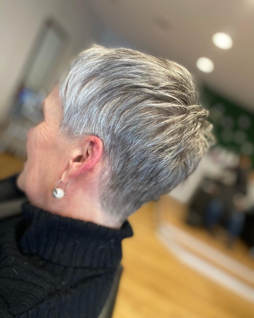 Short silver pixie haircut with textured layers and a lifted crown.
