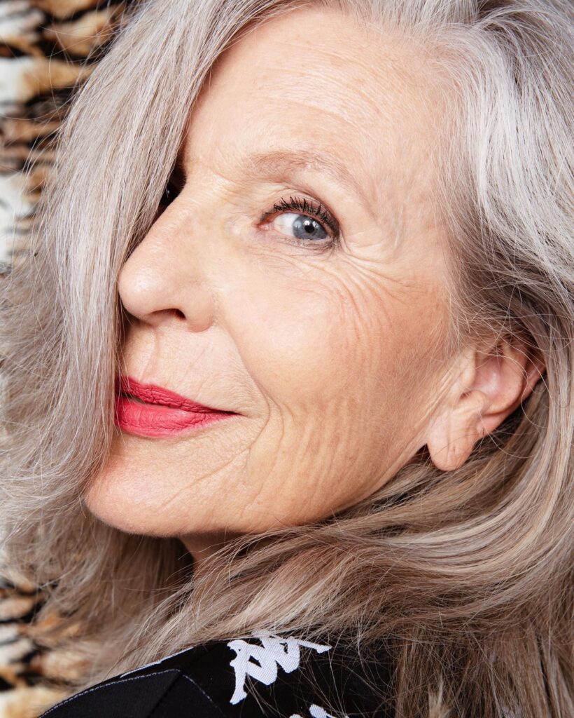 Ear-length silver hairstyle with soft layers and a side swept front.