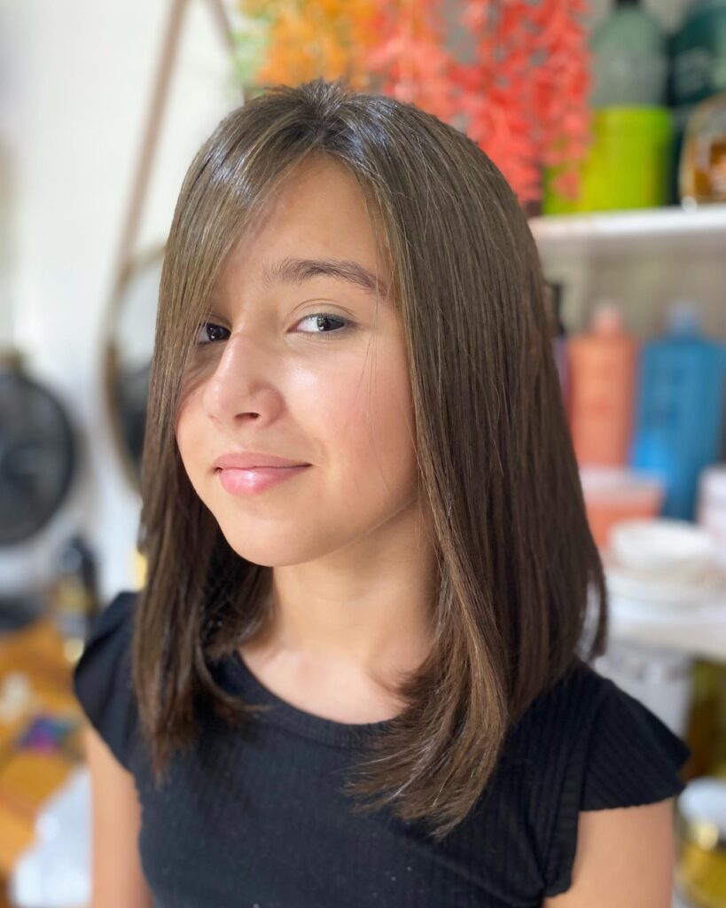 Straight medium brown long bob with soft layers and face framing pieces.