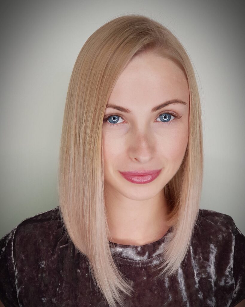 Straight champagne blonde long bob with a soft angled shape and smooth sleek texture.