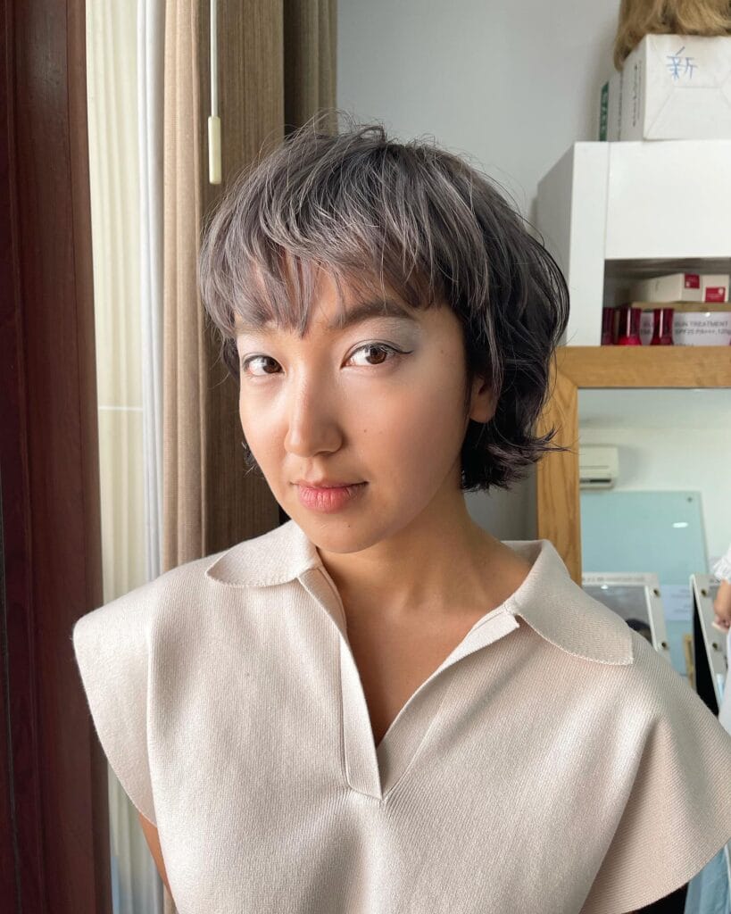 Short textured long bob with soft curtain fringe and choppy layered finish.