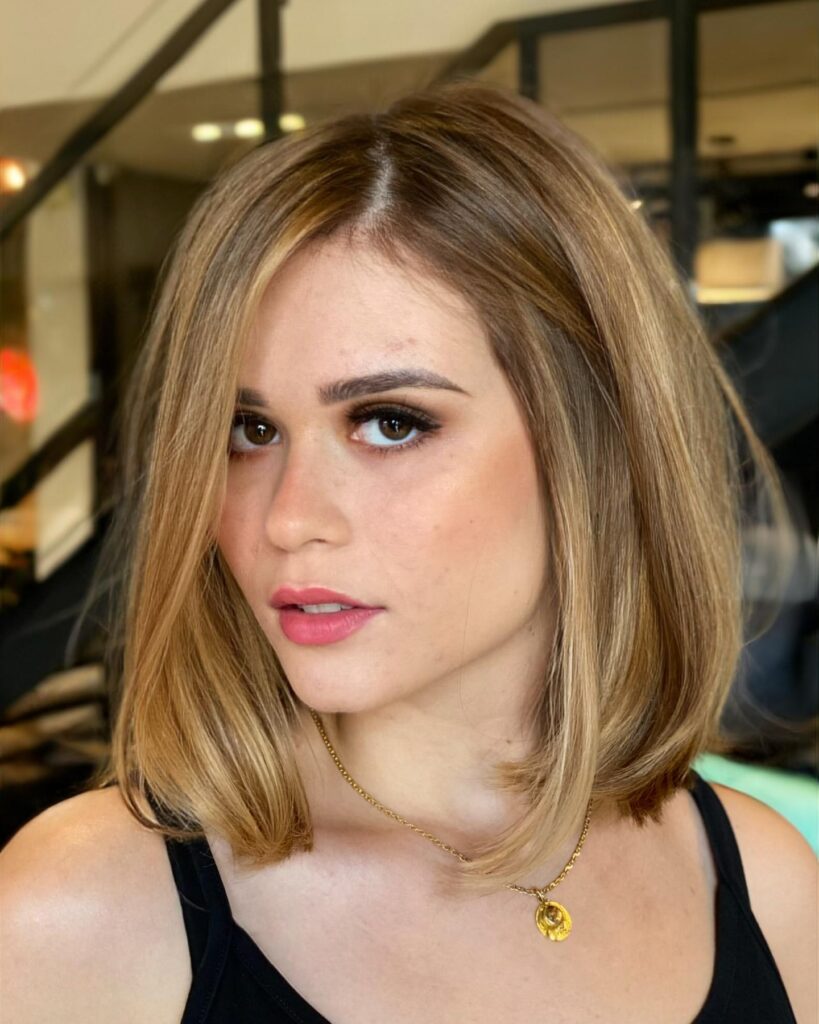 Sleek honey blonde long bob with a deep side part and smooth straight finish.