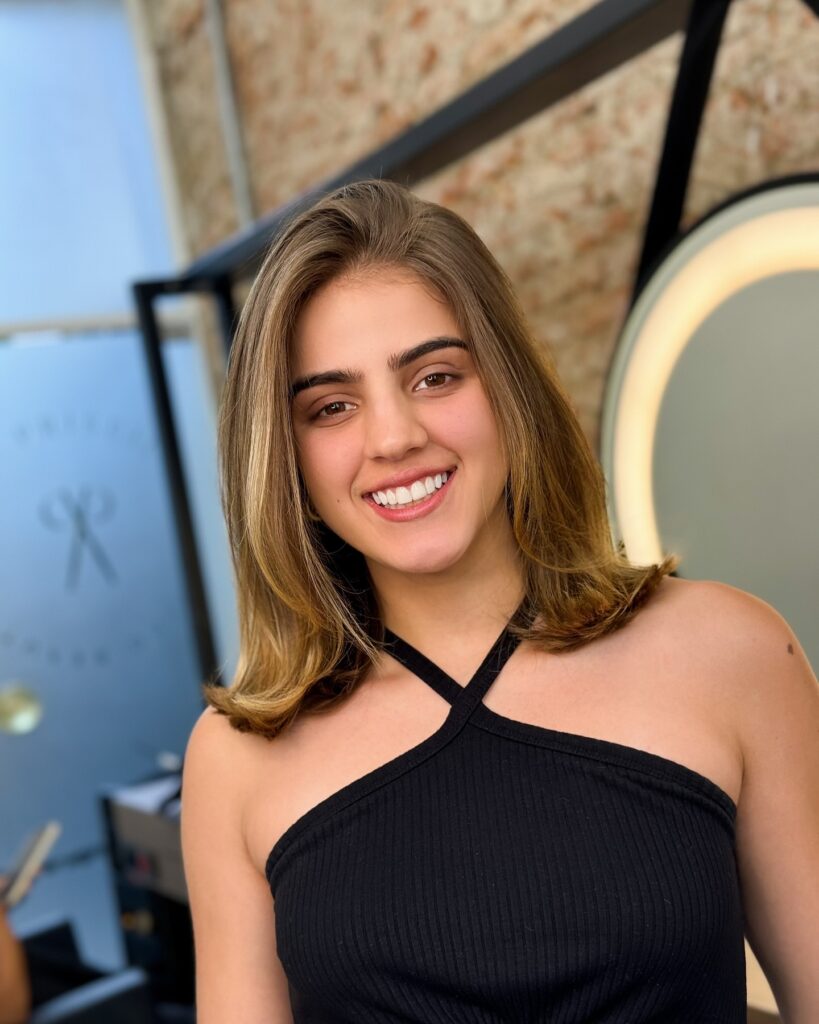 Straight shoulder length brown lob with a center part and subtle layering.