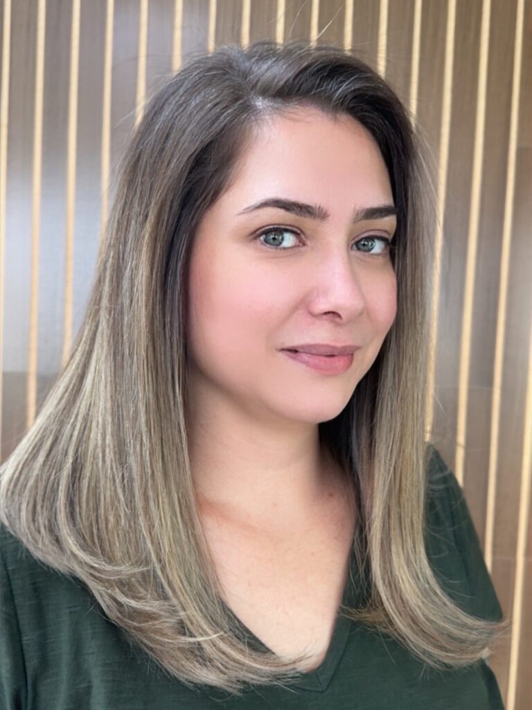 A sleek layered lob with neutral blonde tones and a smooth finish.