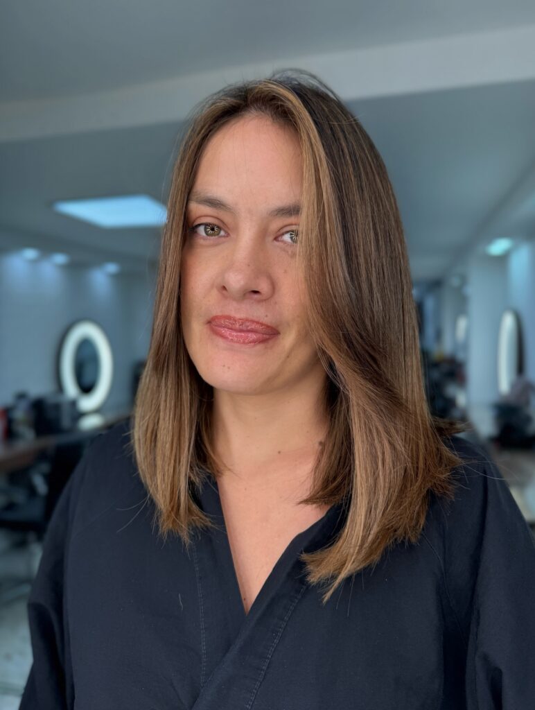 A smooth brunette lob with soft face framing layers and subtle highlights.