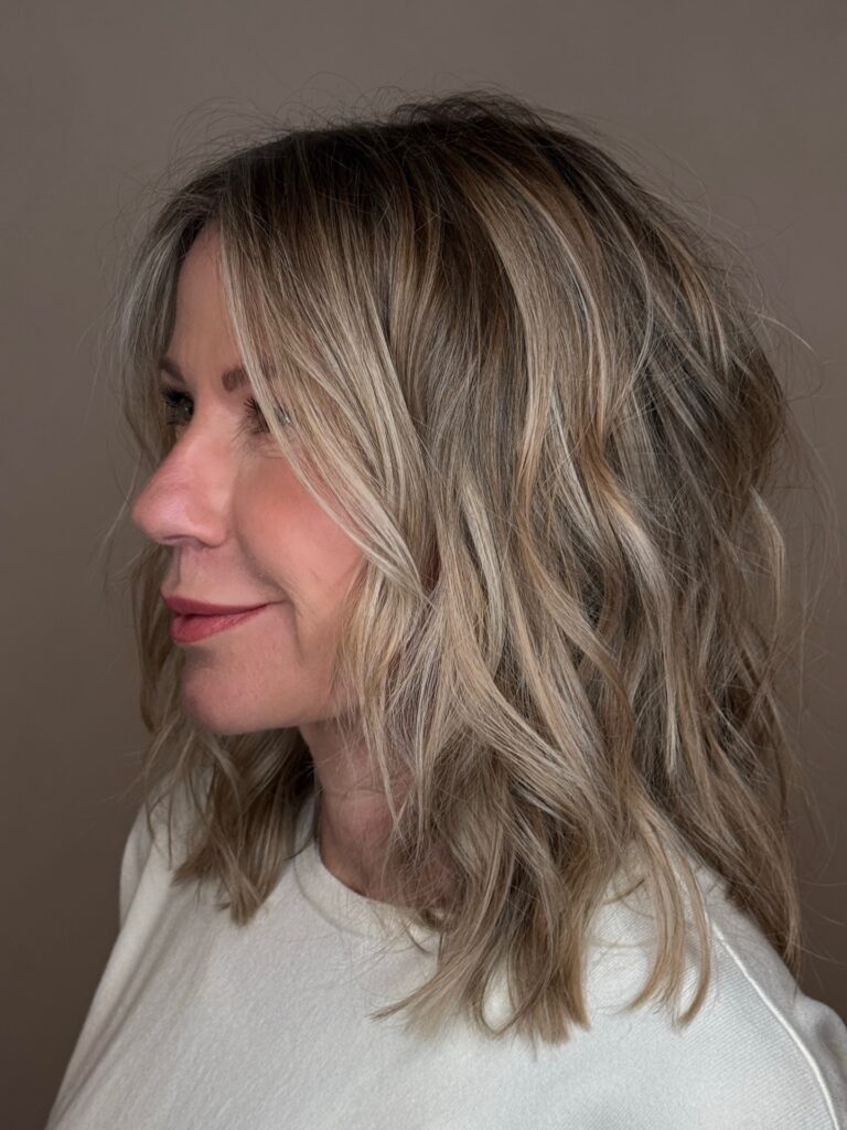 A beachy wavy lob with soft blonde tones and natural texture.