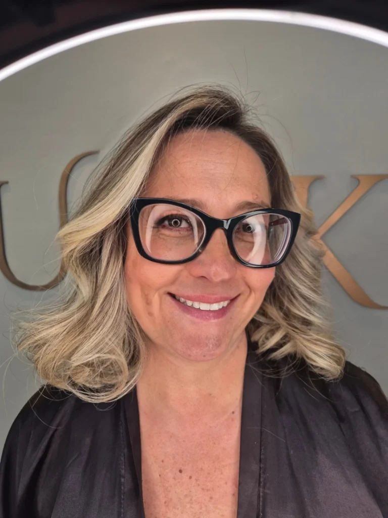 A wavy shoulder length lob with soft blonde tones and natural volume.