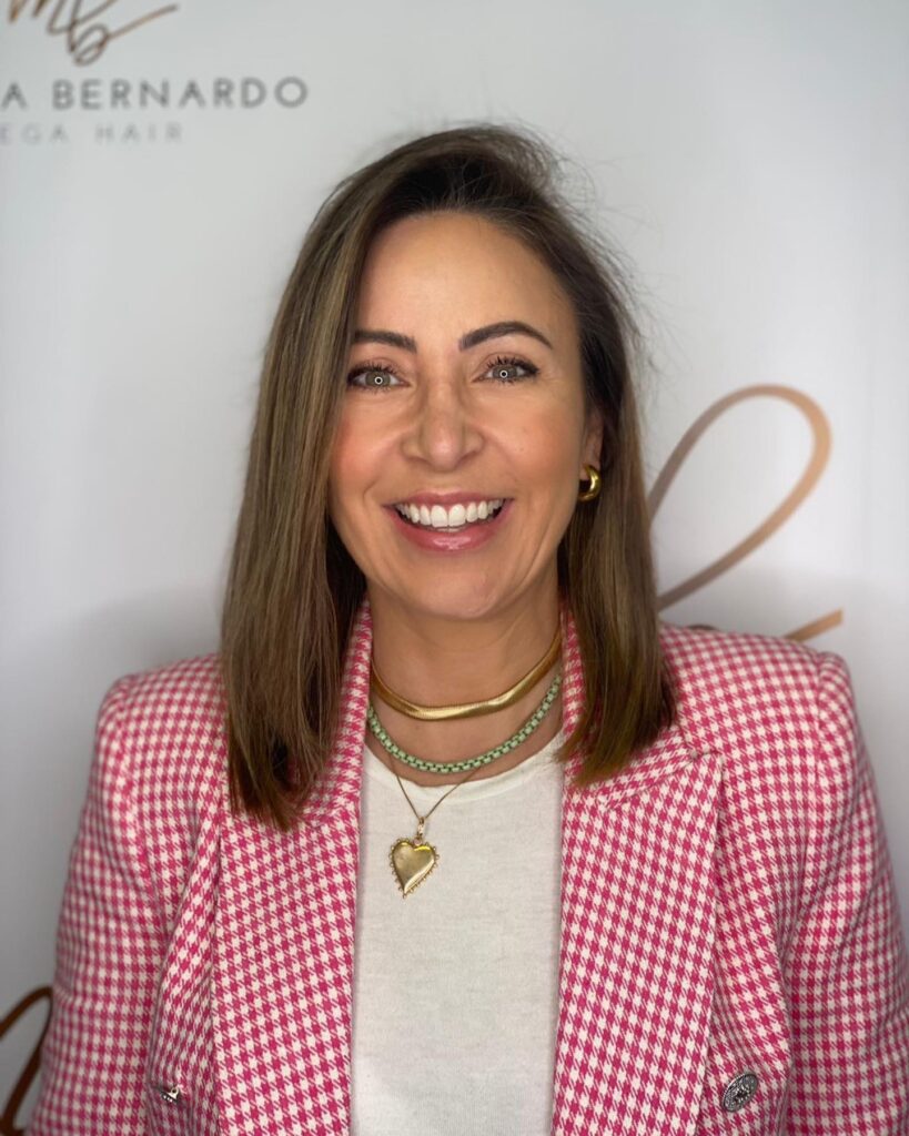 A sleek shoulder length long bob with a soft side part and subtle brown highlights.