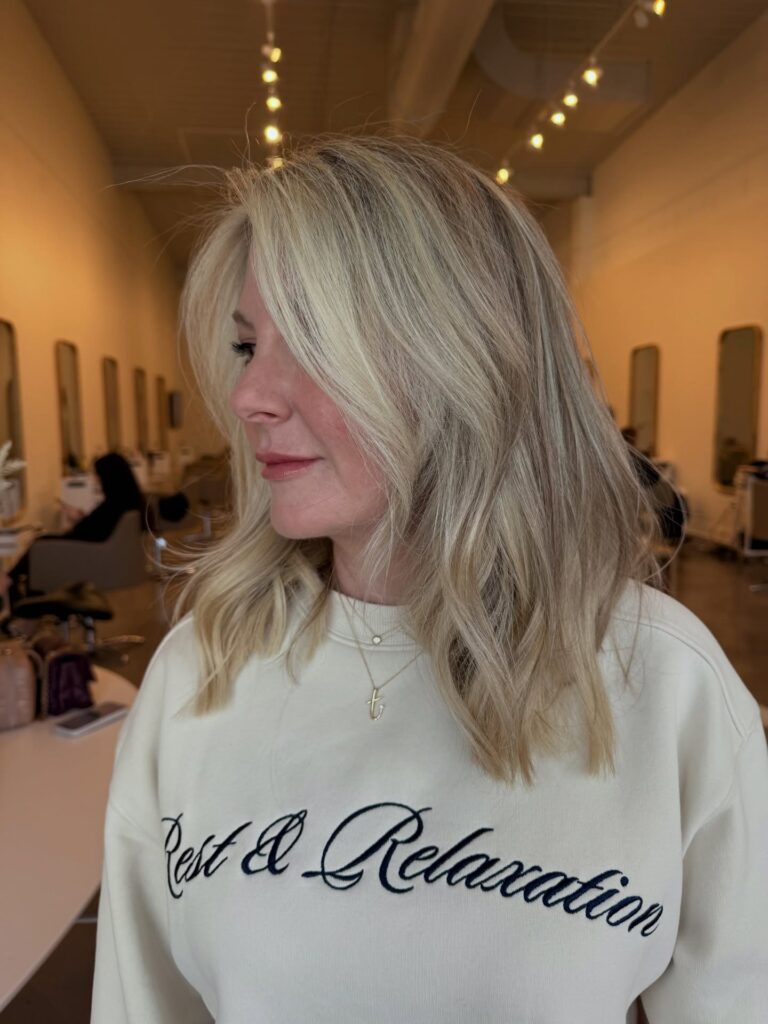 A layered blonde lob with airy volume and soft movement.