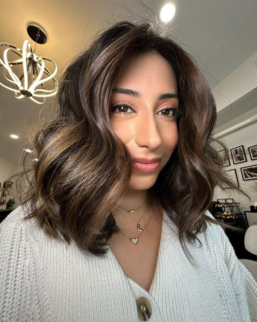 Wavy chocolate brown lob with volume and soft layered ends.