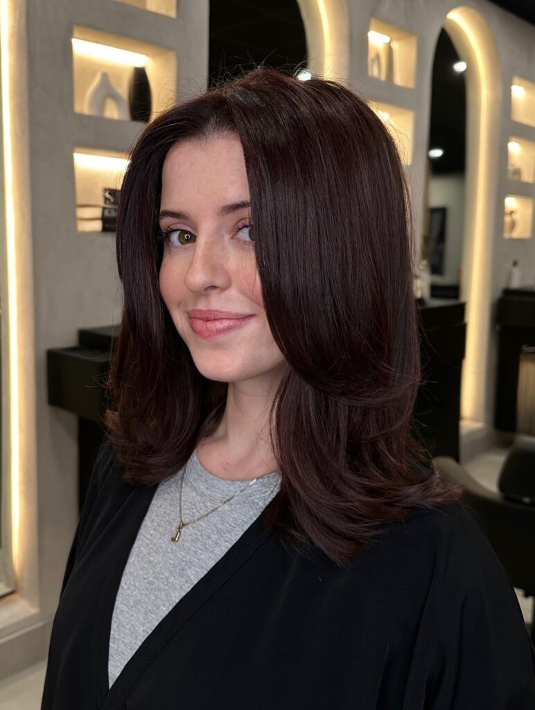 Layered long bob with a voluminous blowout and softly flipped ends.