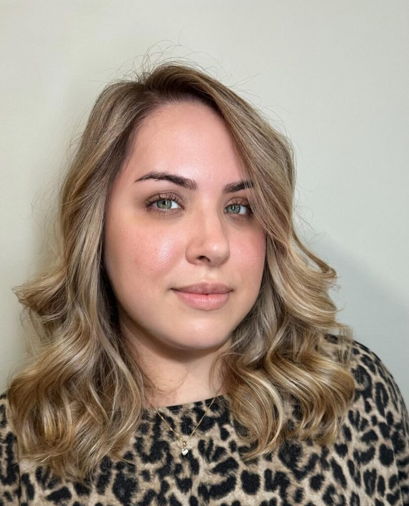 Beige blonde wavy lob with soft layers and natural dimension.