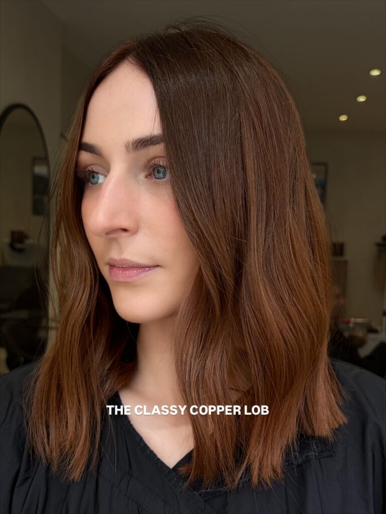 Shoulder length copper lob with soft texture and lightly layered ends.
