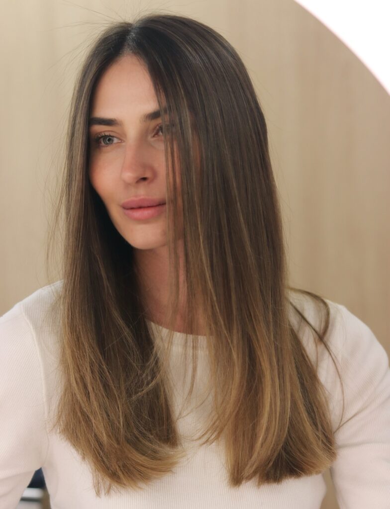 Long layered lob with face framing pieces and soft natural highlights.