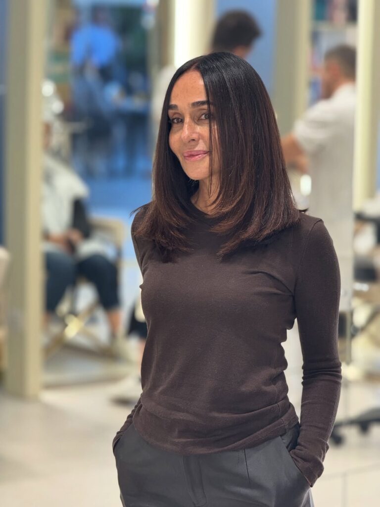 Sleek straight long bob with a center part and soft inward layers at the ends.