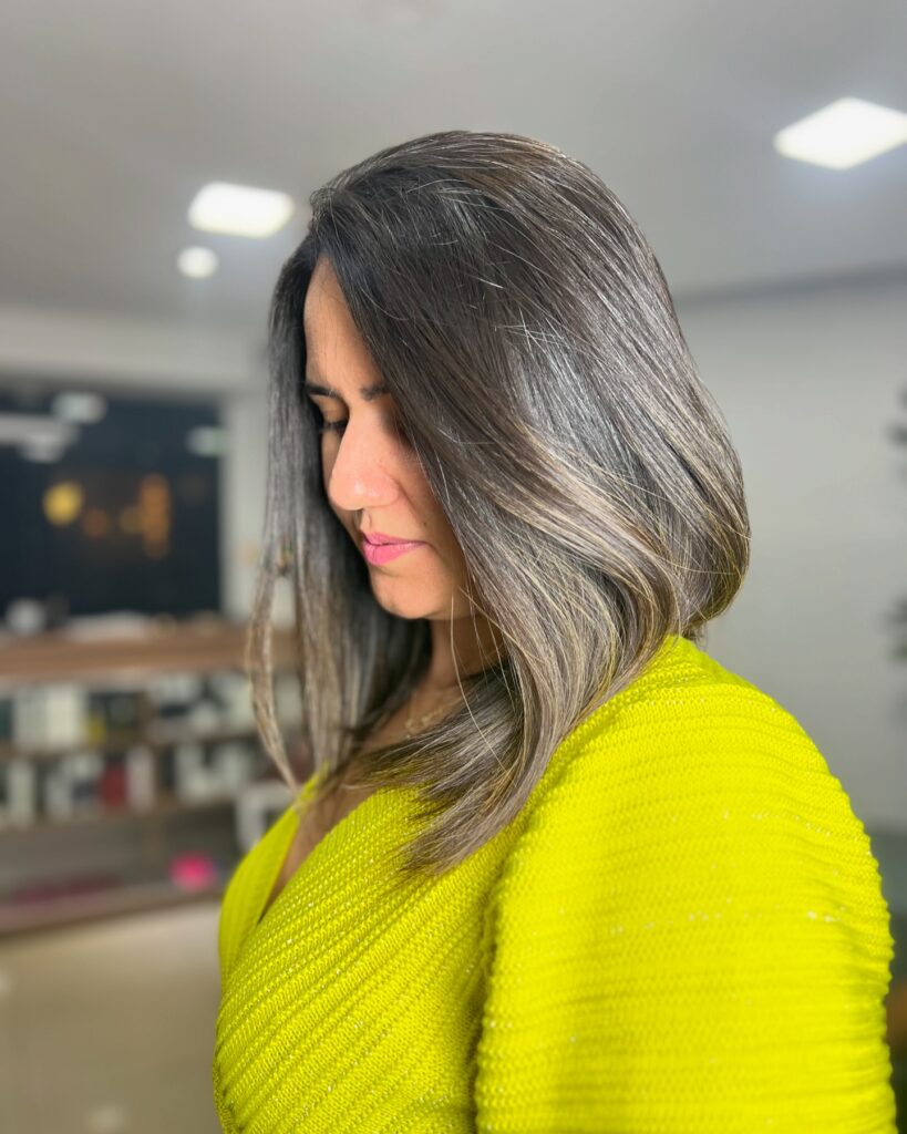 Sleek angled lob with ash brown color and longer front pieces.