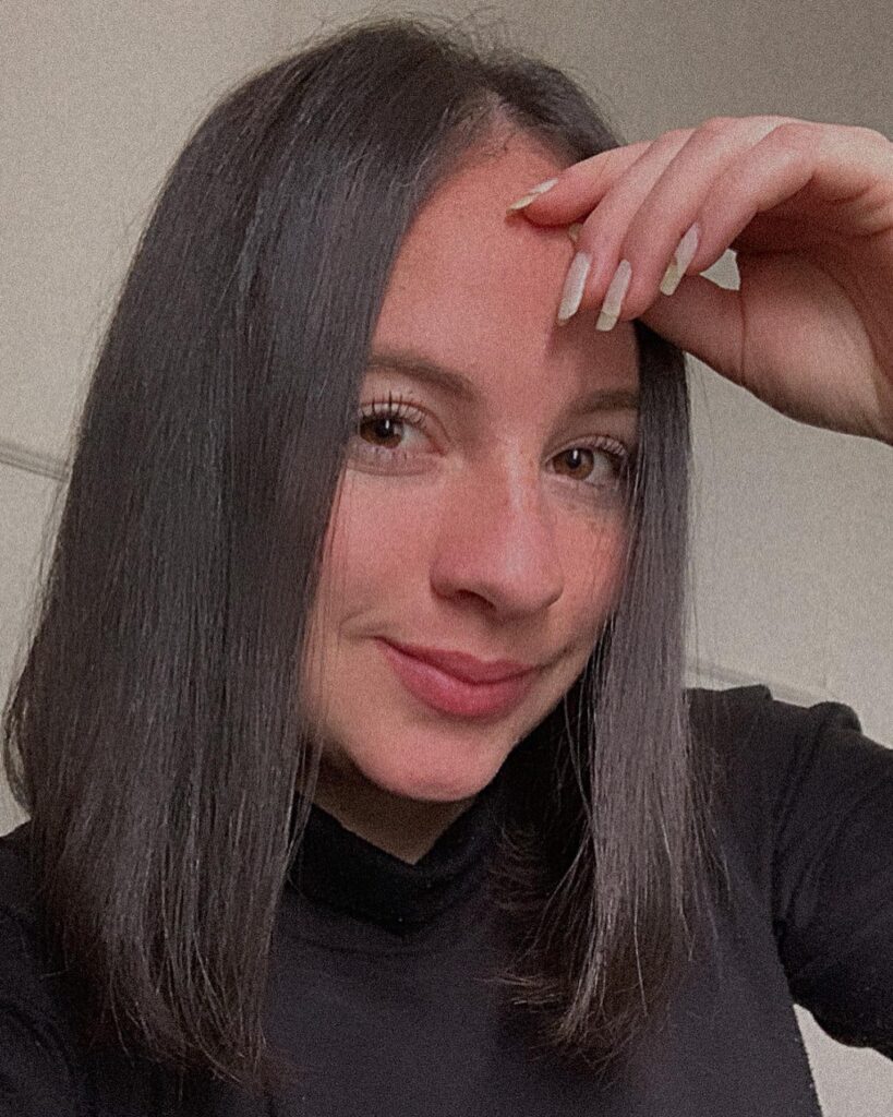 Straight dark brown long bob with a center part and sleek finish.