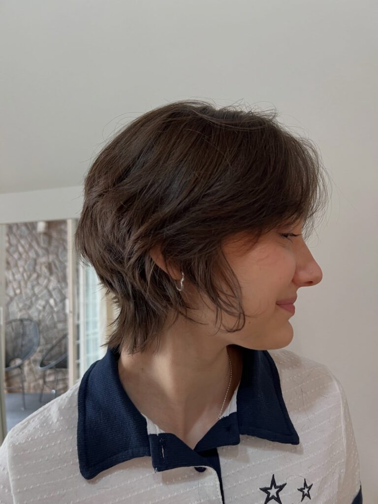 Brown layered pixie mullet with soft shaggy texture and a longer wispy nape.