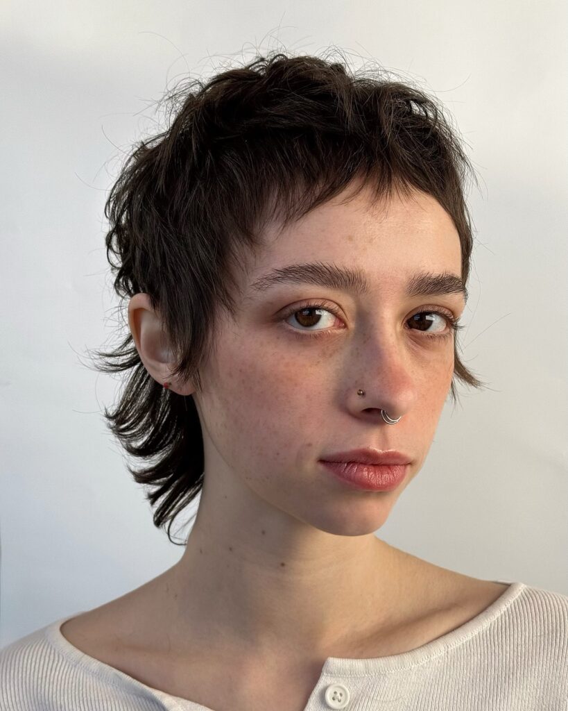 Short feathered pixie mullet with wispy layers and flipped ends at the back.