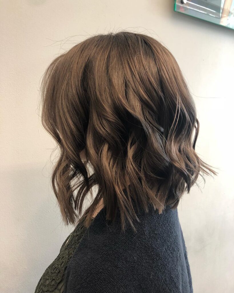 A chocolate brown textured lob with loose waves and choppy ends.