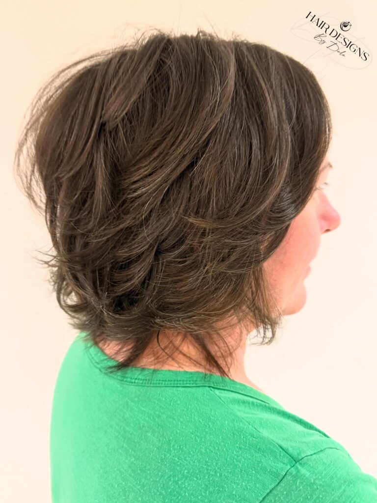 A feathered brunette bob with layered volume and softly flipped ends.