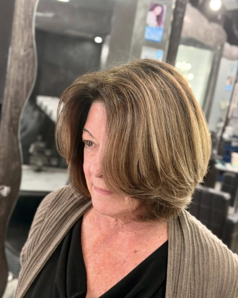 Layered caramel brown bob with voluminous shape and flipped ends.