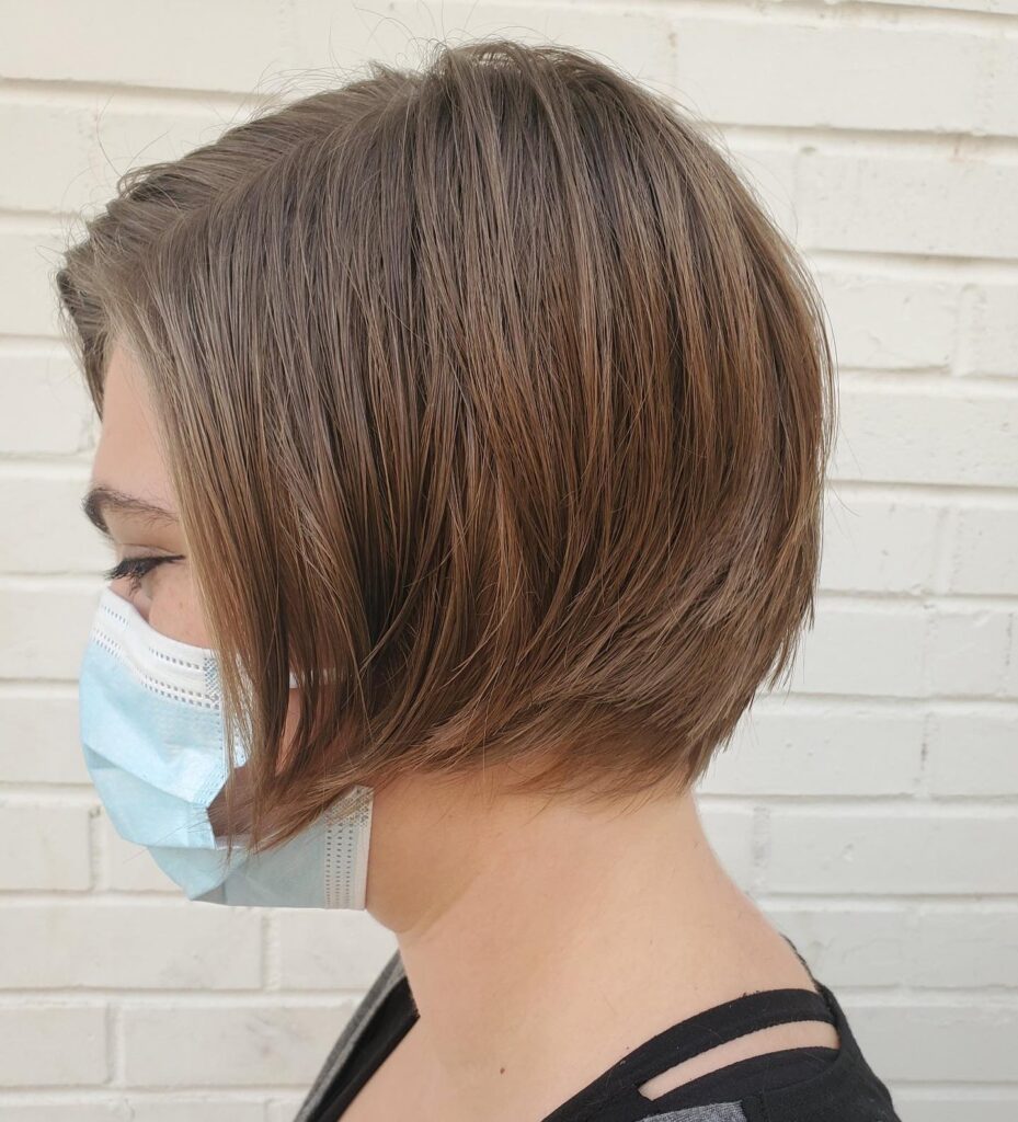 A tapered brunette bob with soft stacked layers and longer front pieces.