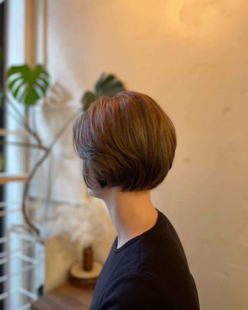 A sleek espresso brunette bob with curved layers and rounded volume.