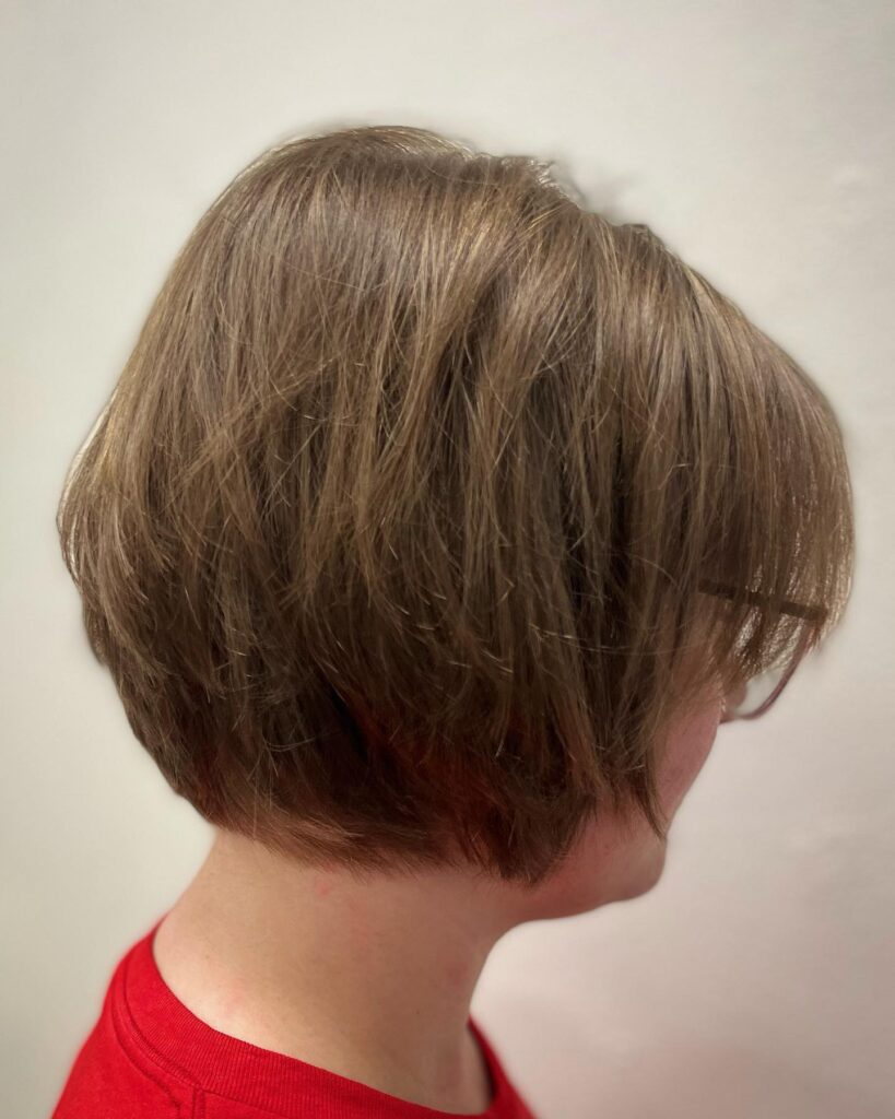 A soft brunette bob with wispy layered ends and natural dimension.
