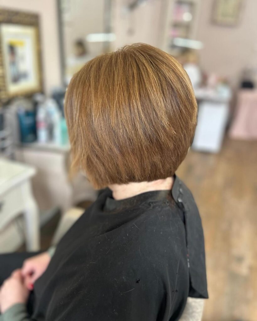 A classic brunette bob with smooth rounded volume and subtle layered shaping.