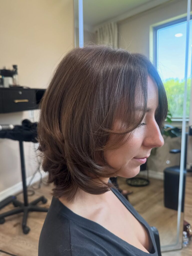 Chocolate brown layered bob with feathered ends and soft curtain fringe.