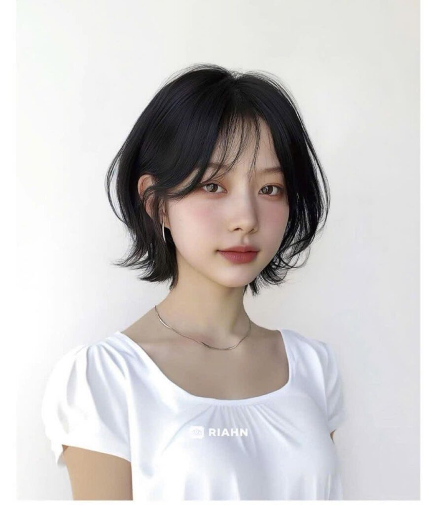 Soft black Korean bob with curtain fringe and airy flipped layers.