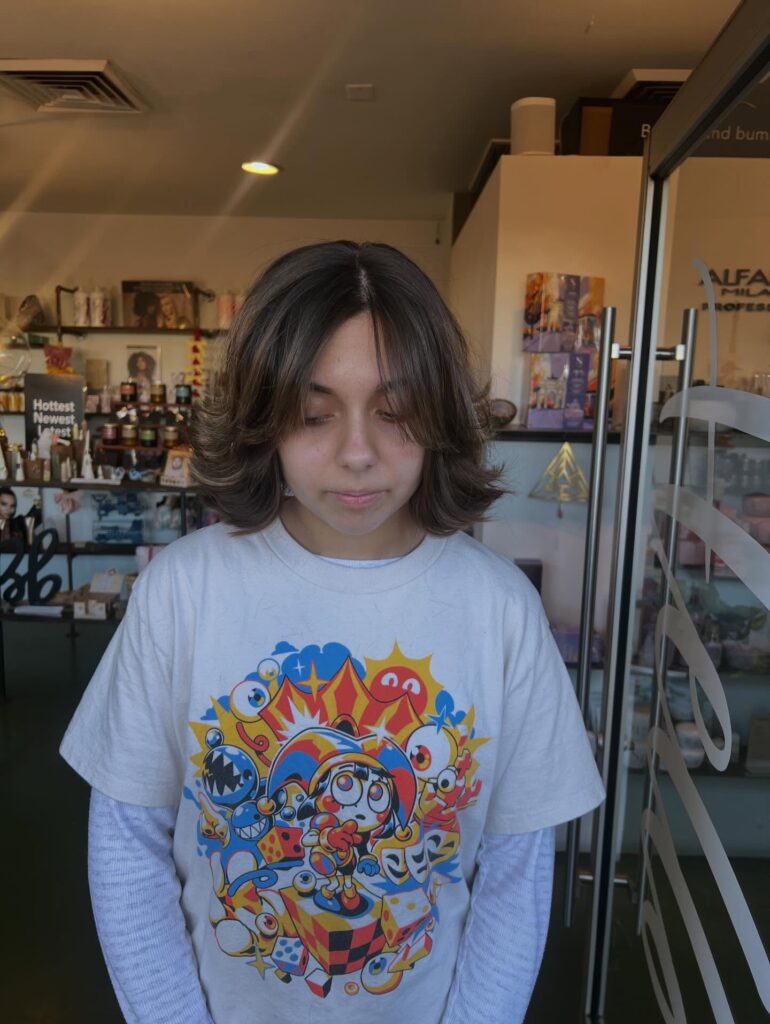 Medium layered bob with feathered flipped ends and soft curtain layers framing the face.