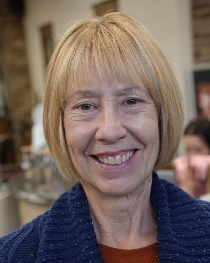 Classic blonde sleek bob with soft fringe and smooth straight layers.