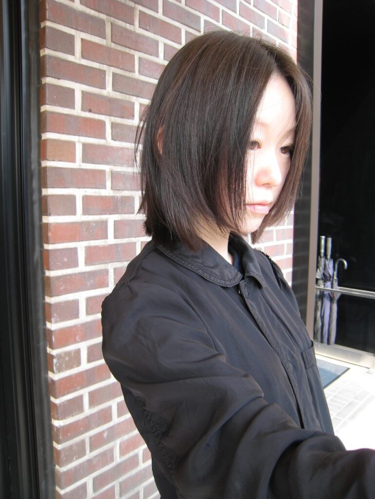A sleek black Japanese-style bob with long face-framing layers and straight ends.