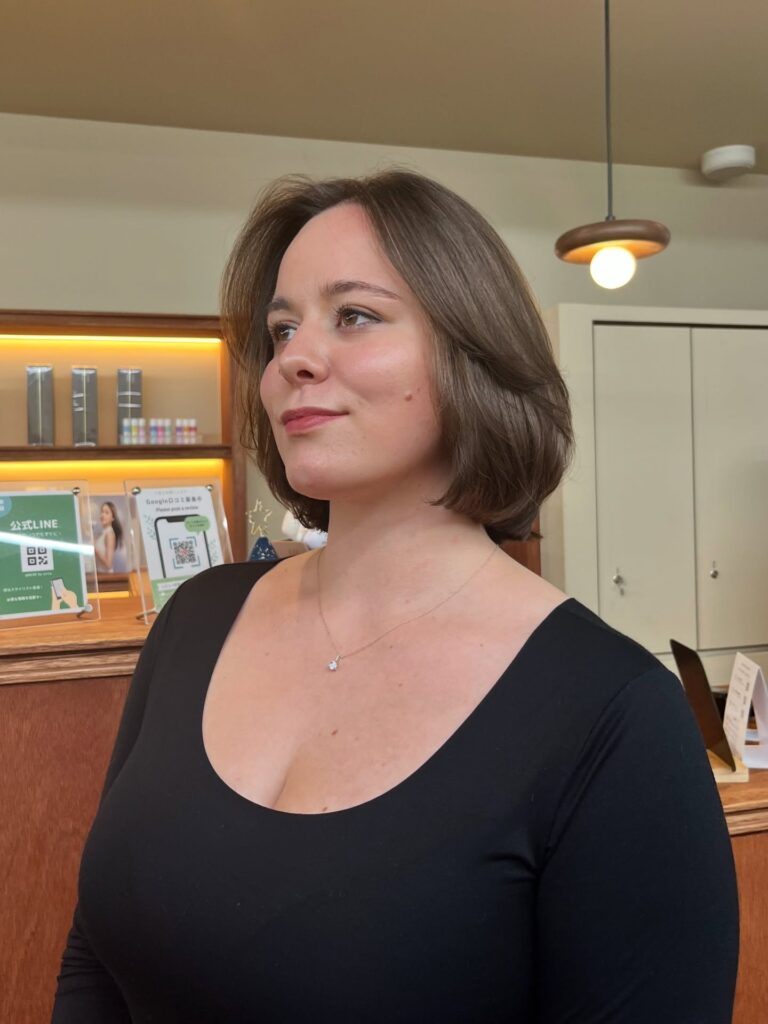 Smooth brunette layered bob with soft face-framing pieces and rounded volume.
