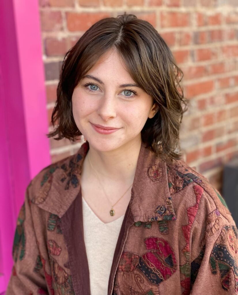 Textured brunette bob with soft layers and wispy front pieces.