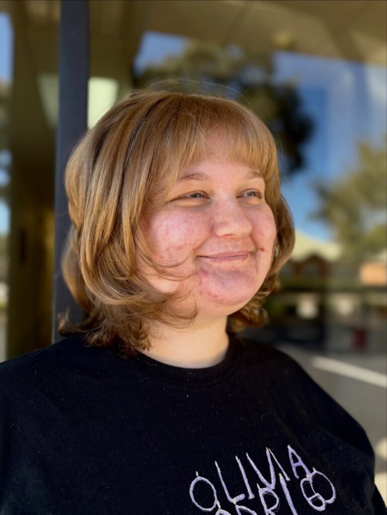 Golden blonde layered bob with flipped out ends and feathered layers.