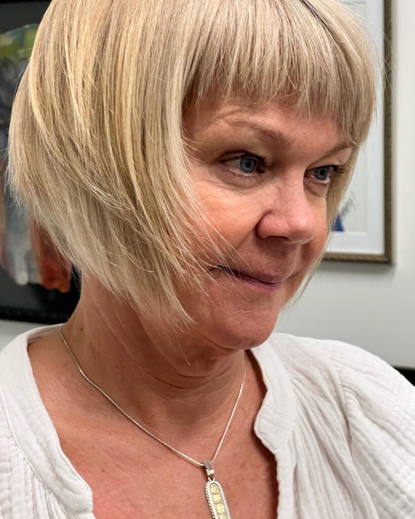 Smooth blonde bob with tapered sides and a soft blunt fringe.