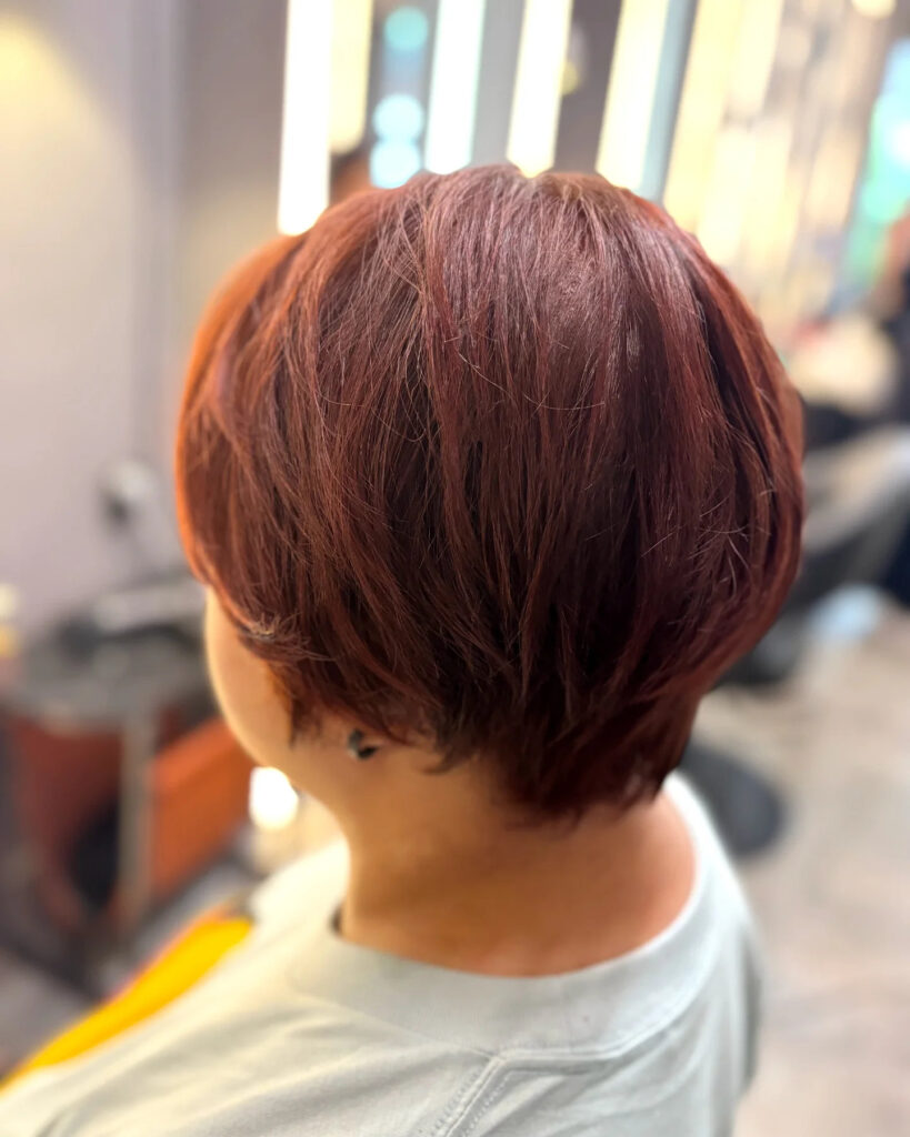 Stacked auburn bob with tapered layers and soft volume in the back.