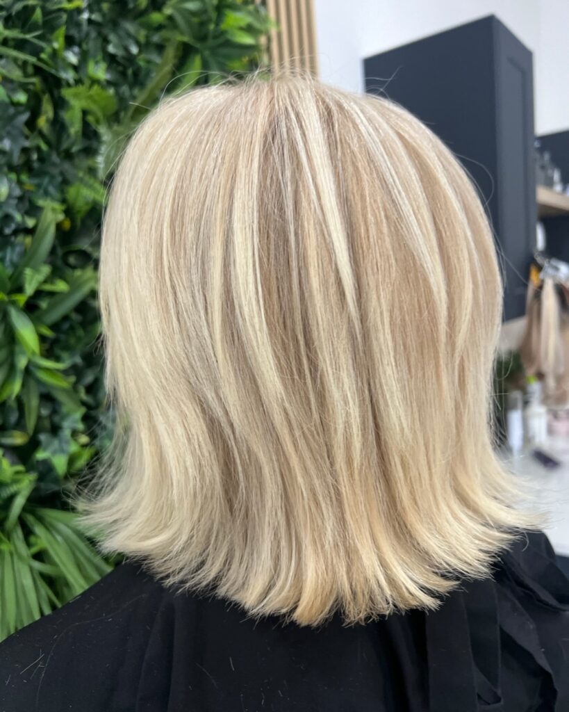 Textured creamy blonde bob with piecey flipped-out ends and soft layers.