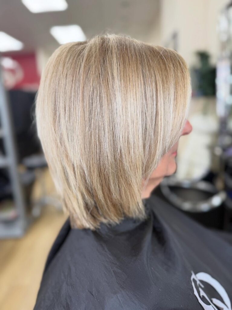 A sleek angled beige-blonde bob with fine layers and smooth straight styling.