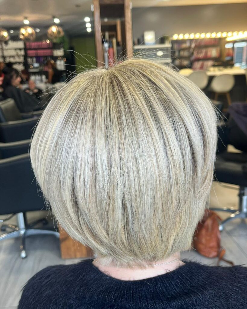 Rounded silver blonde bob with smooth layers and a softly curved shape.