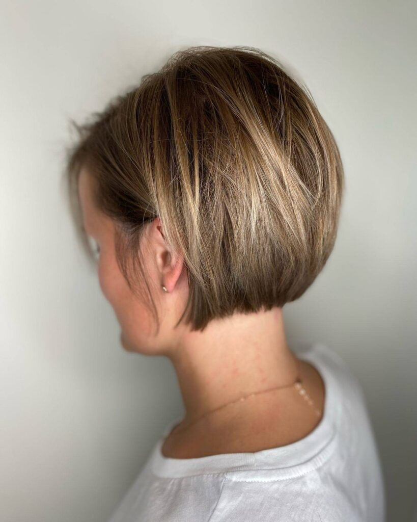 Stacked beige blonde bob with soft layers and dimensional highlights.
